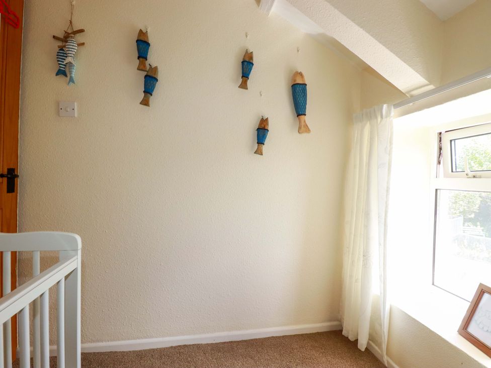 A children's room with fish decorations on the wall and a window at Brockstone Cottage St Austell