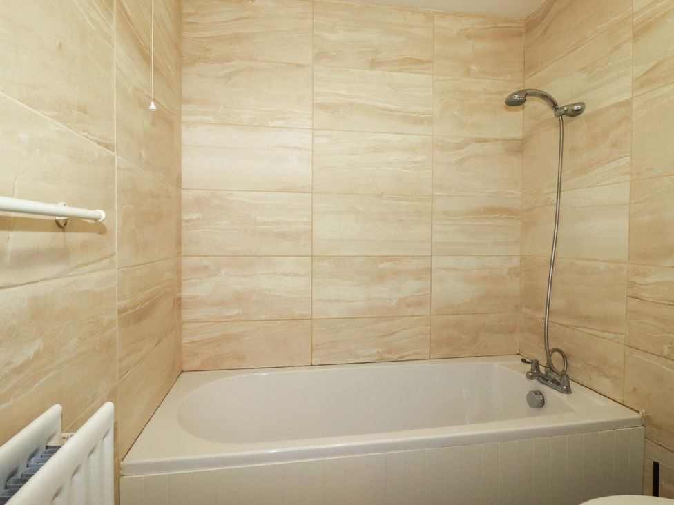 A bathroom with a bathtub and shower at Brockstone Cottage St Austell