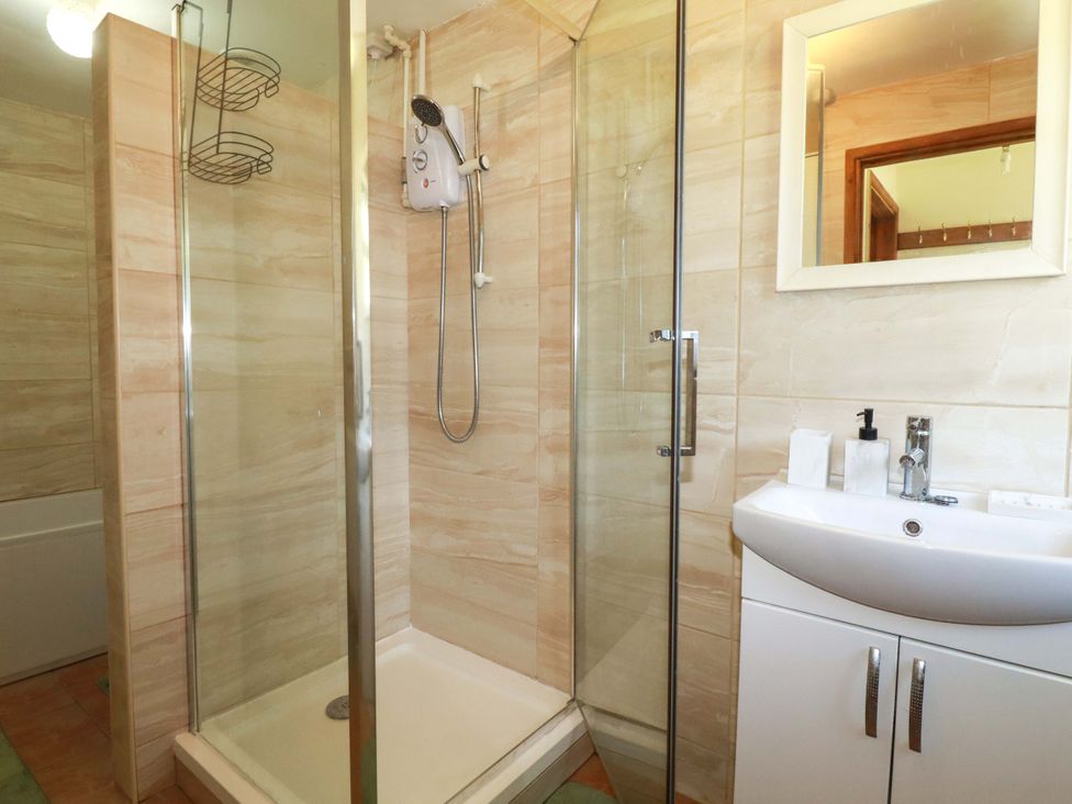 A bathroom with a shower and sink at Brockstone Cottage St Austell