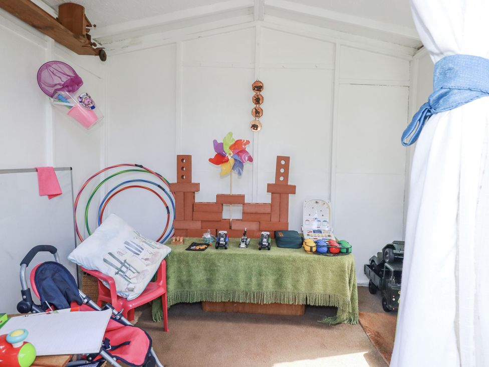 A playroom with hula hoops and toys at Brockstone Cottage in St Austell