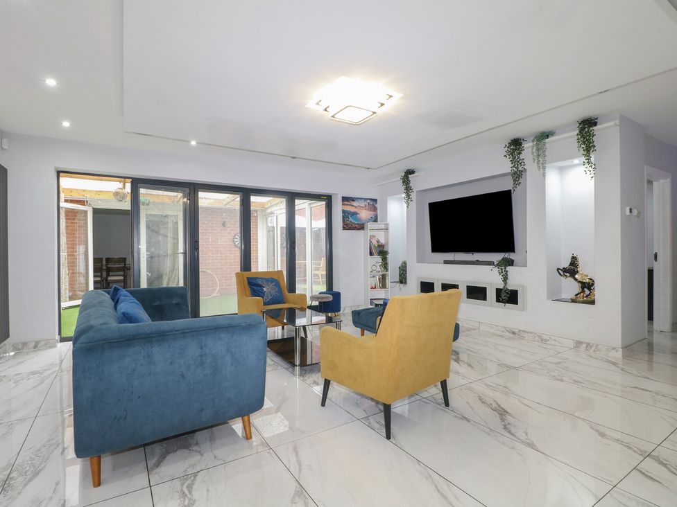 A living room with sofas and a television at Falcon Bal House