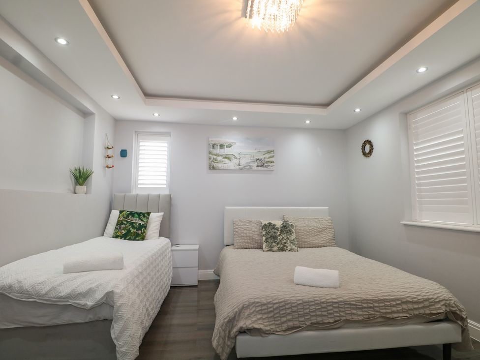 A bedroom with two beds and wall art at Falcon Bal House