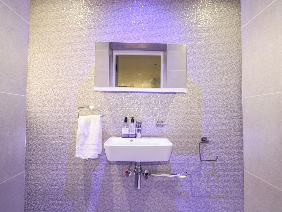 A sink with a mirror and towel in the bathroom at Falcon Bal House