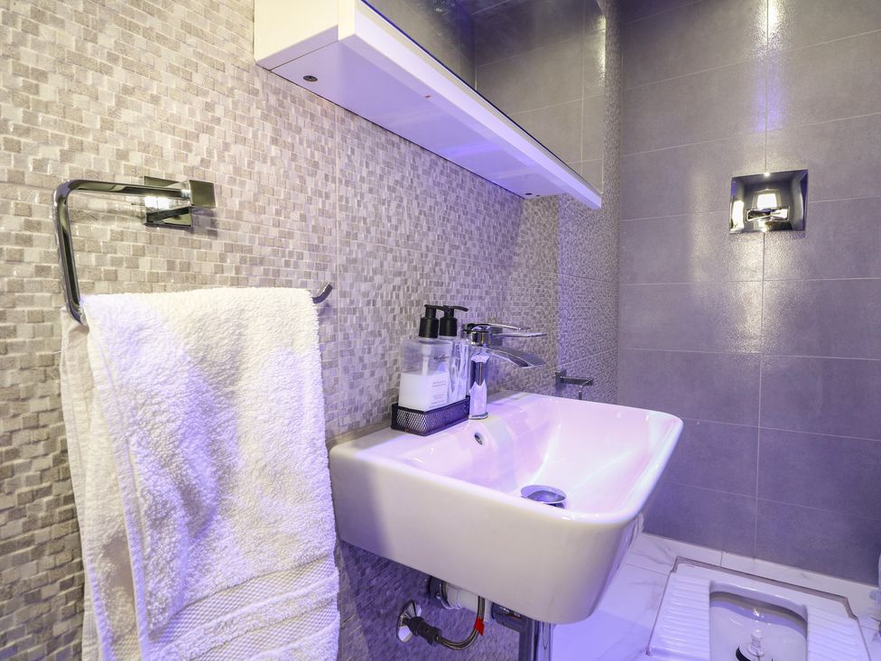 A sink with a towel and soap dispenser in a bathroom at Falcon Bal House