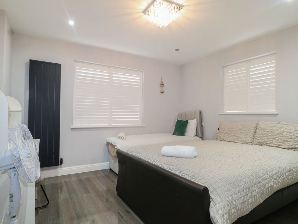 A bedroom with two beds and a fan at Falcon Bal House