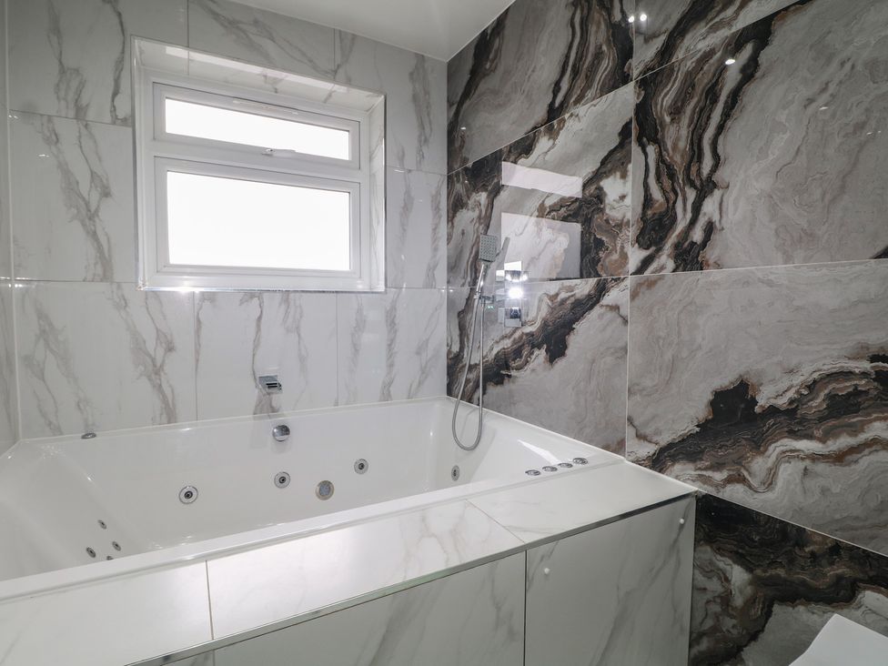 A bathroom with a bathtub and shower at Falcon Bal House