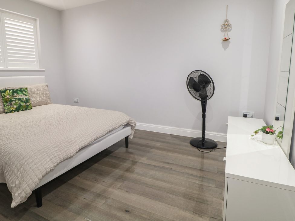 A bedroom with a bed and fan at Falcon Bal House