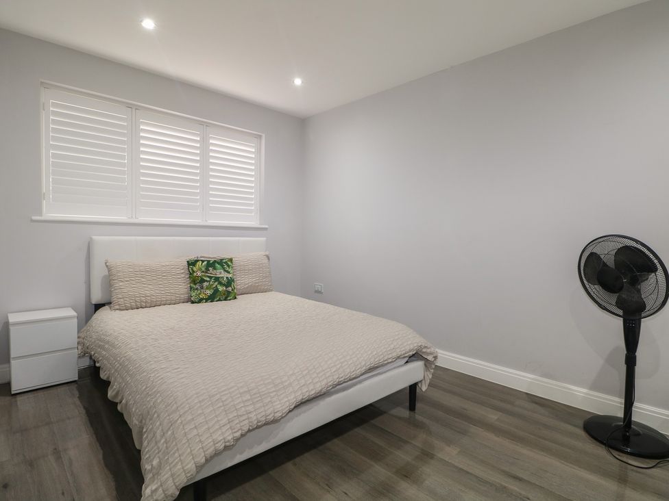 A bedroom with a bed and a fan at Falcon Bal House