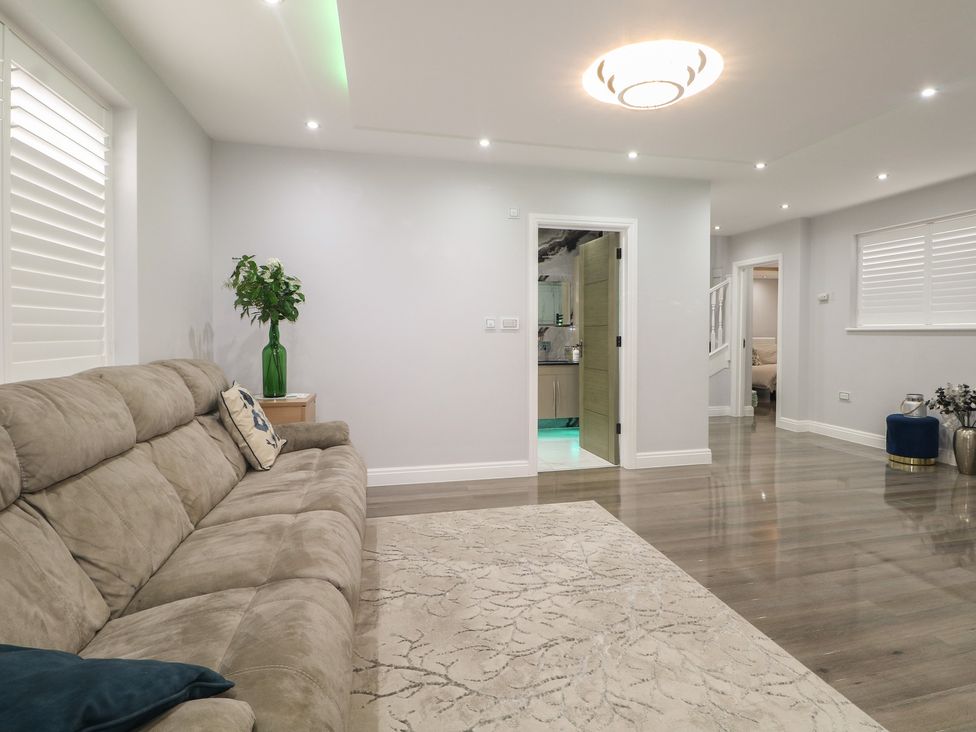 A living room with a sofa and a plant at Falcon Bal House