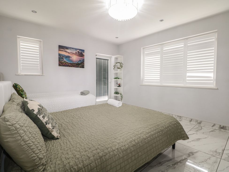 A bedroom with two beds and a shelf at Falcon Bal House