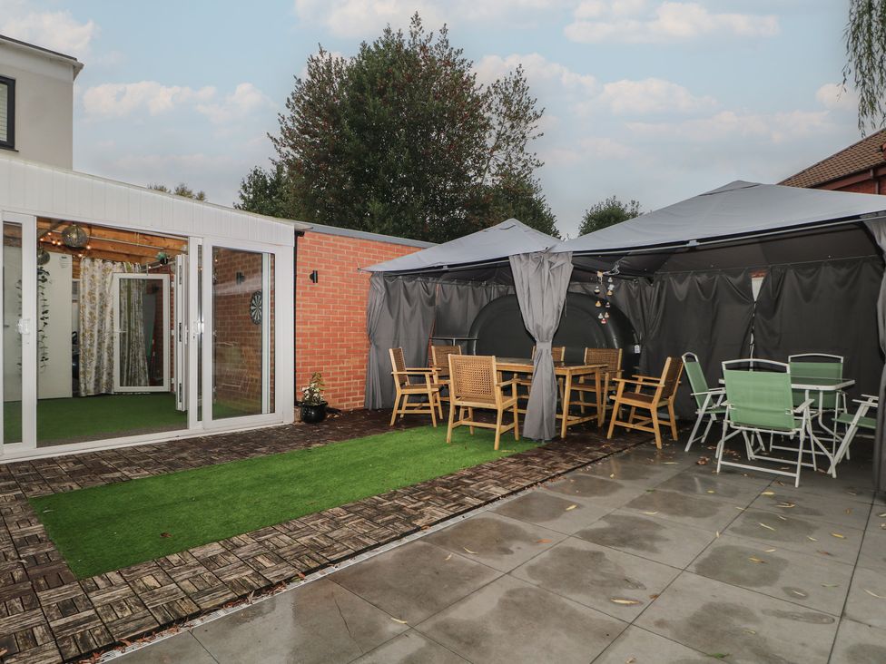 An outdoor area with a gazebo and seating at Falcon Bal House