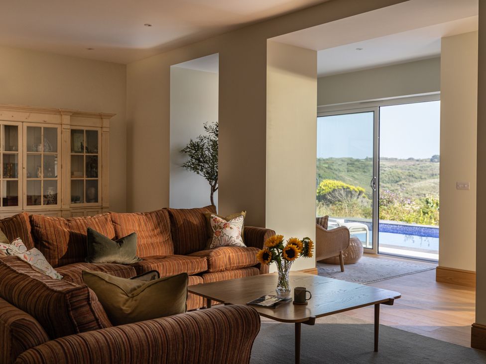 A living room with a sofa and coffee table at Trevean in Mullion