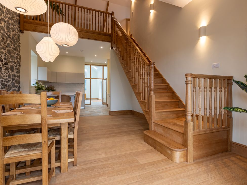 A dining room with a table and chairs at Trevean in Mullion