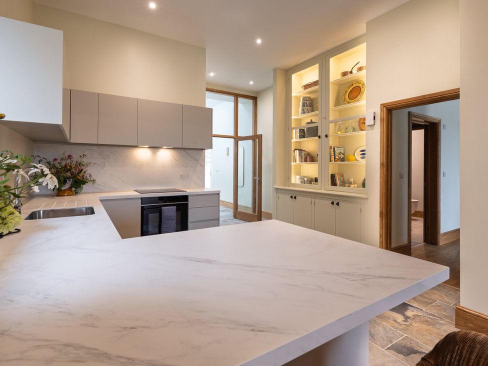 A kitchen with modern cabinetry and shelving at Trevean in Mullion