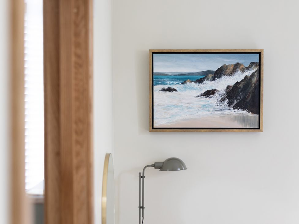 A wall painting and a lamp in a living room at Trevean in Mullion