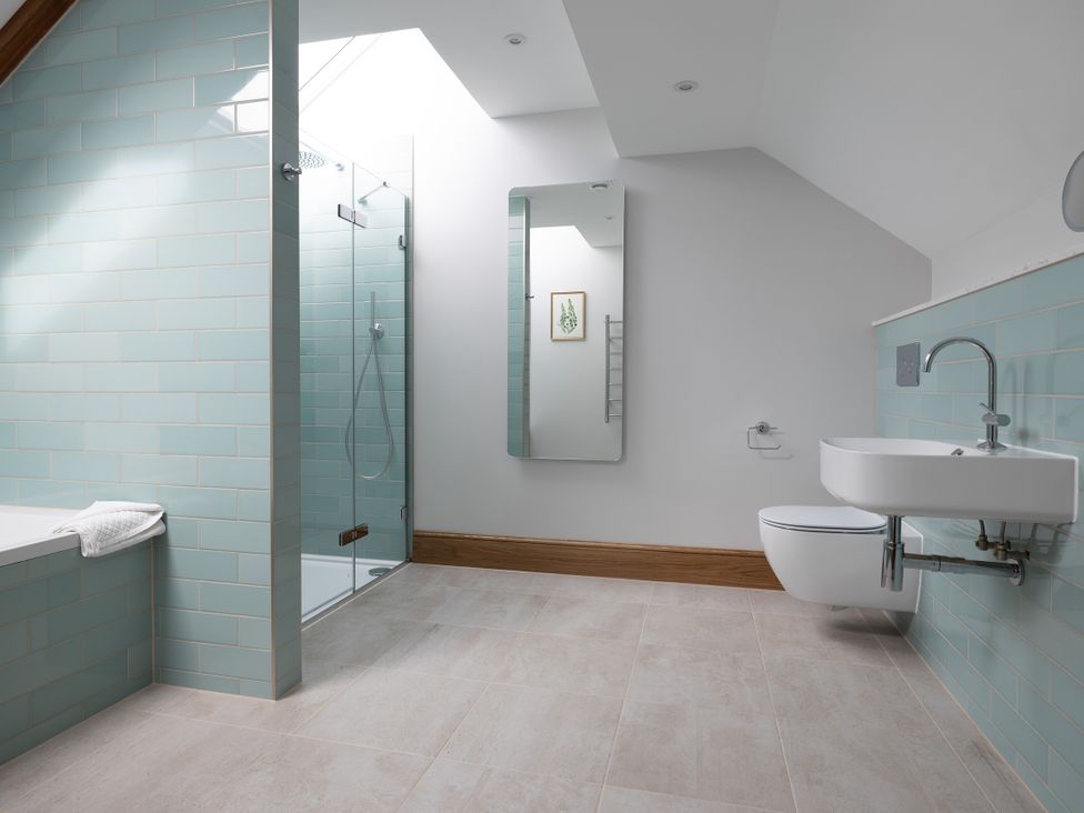 A bathroom with a shower and bathtub at Trevean in Mullion