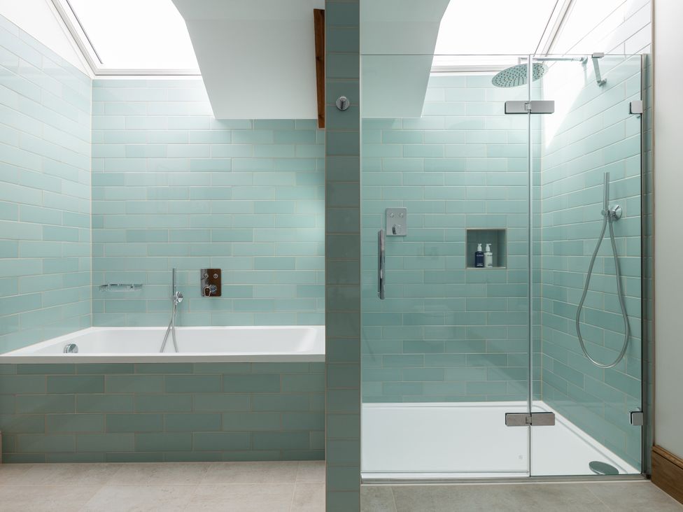 A bathroom with a bathtub and shower at Trevean in Mullion