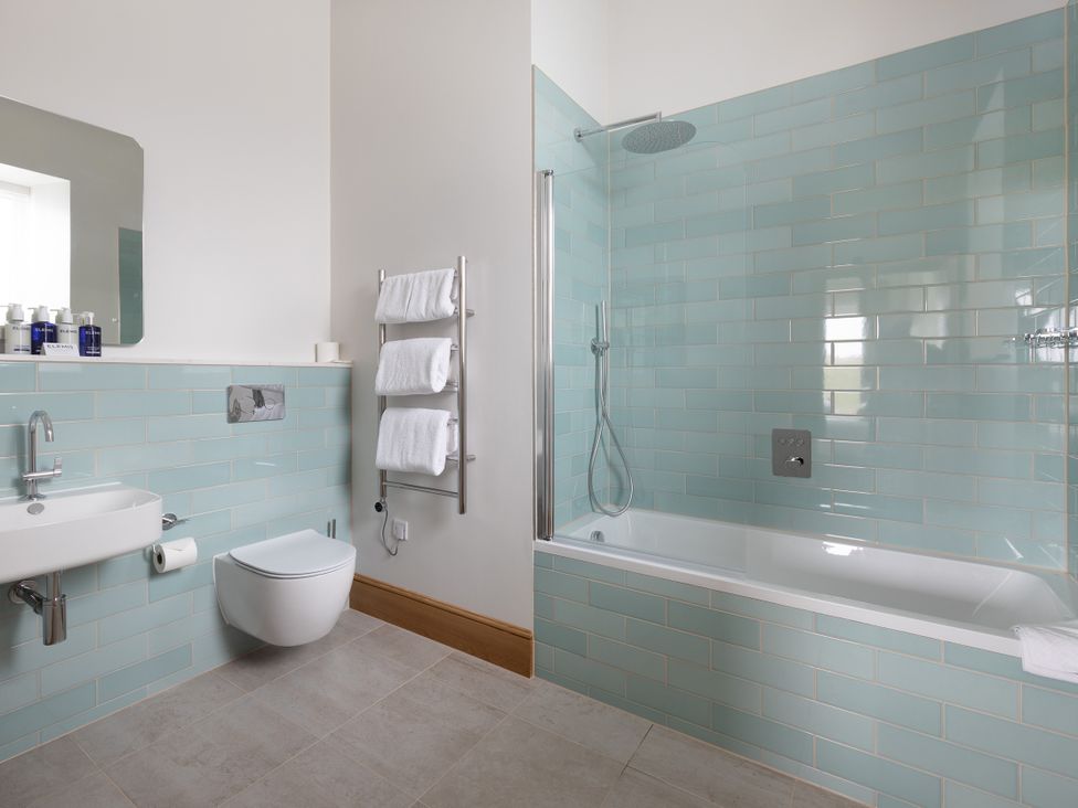 A bathroom with a sink, toilet, shower, and bathtub at Trevean in Mullion