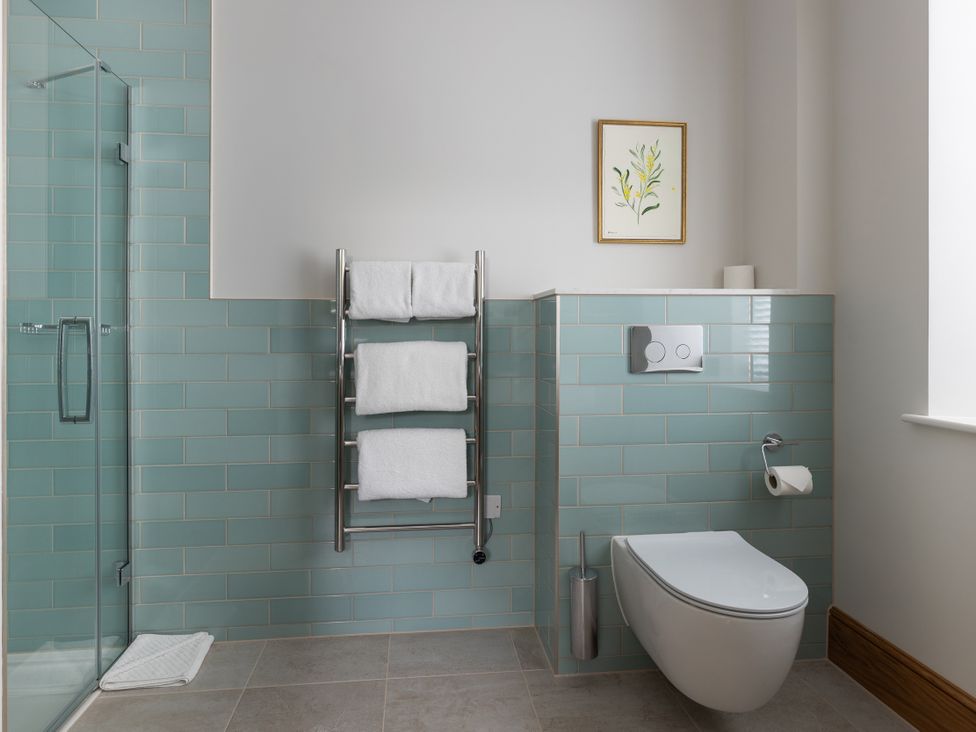 A bathroom with shower and towels on a rack at Trevean in Mullion