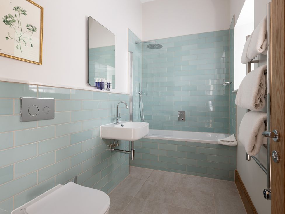 A bathroom with a shower and bathtub at Trevean in Mullion