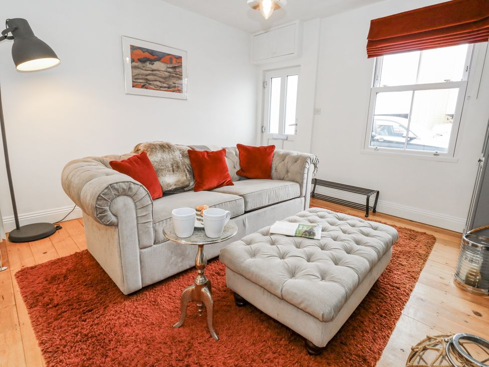 A living room with a sofa and coffee table at Fisherman’s Cottage