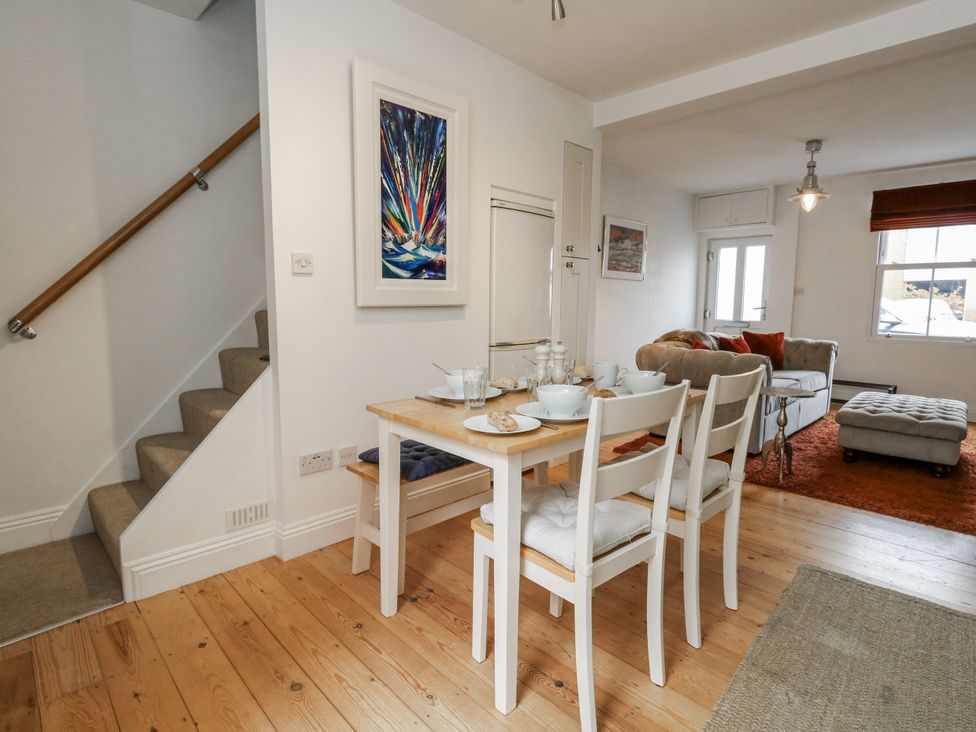 A dining area with table and chairs at Fisherman’s Cottage