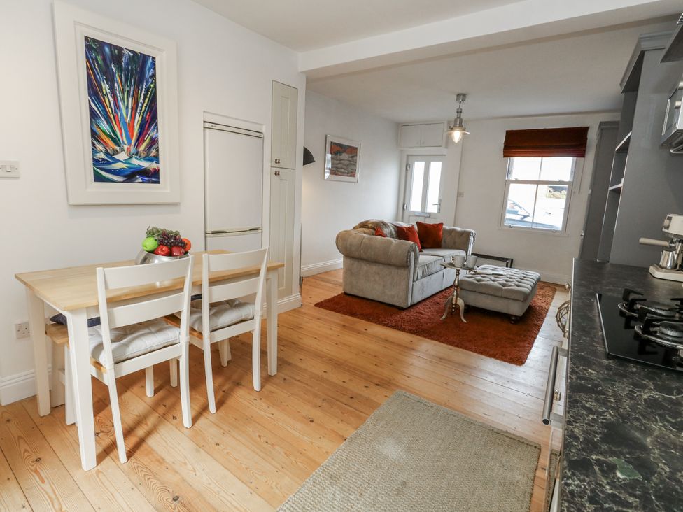 A kitchen with a dining table and seating at Fisherman’s Cottage 