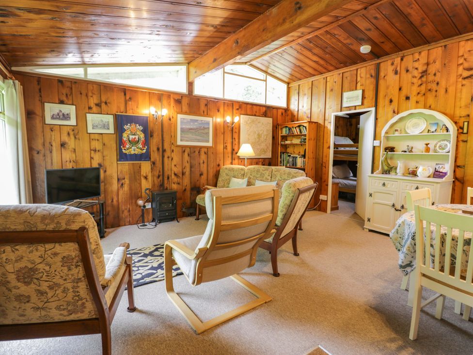 A living room with a sofa and television at Ty Bedwen in Dinas Mawddwy
