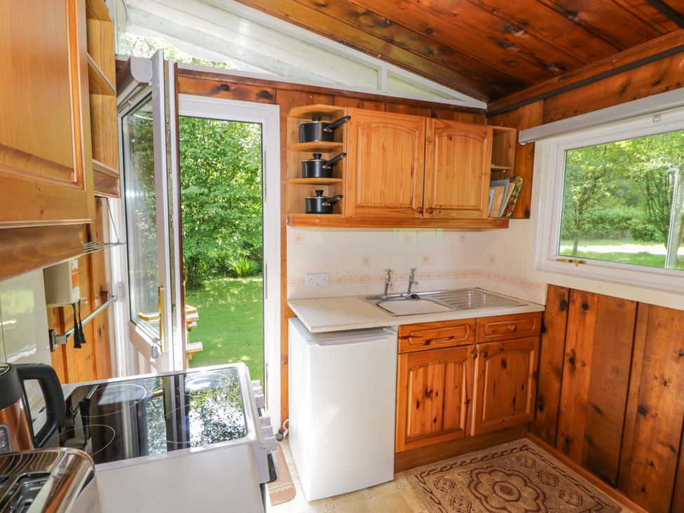 A kitchen with cabinets and a sink at Ty Bedwen in Dinas Mawddwy