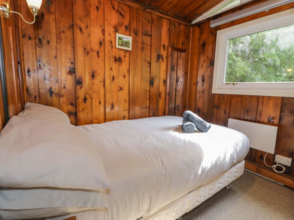 A bedroom with a bed and window at Ty Bedwen in Dinas Mawddwy