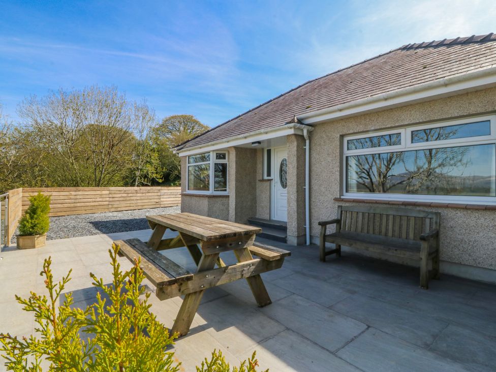 An outdoor area with a picnic table and a bench at Tirionfa in Talsarnau