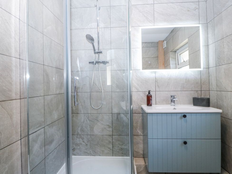 A bathroom with a shower and sink at Tirionfa in Talsarnau