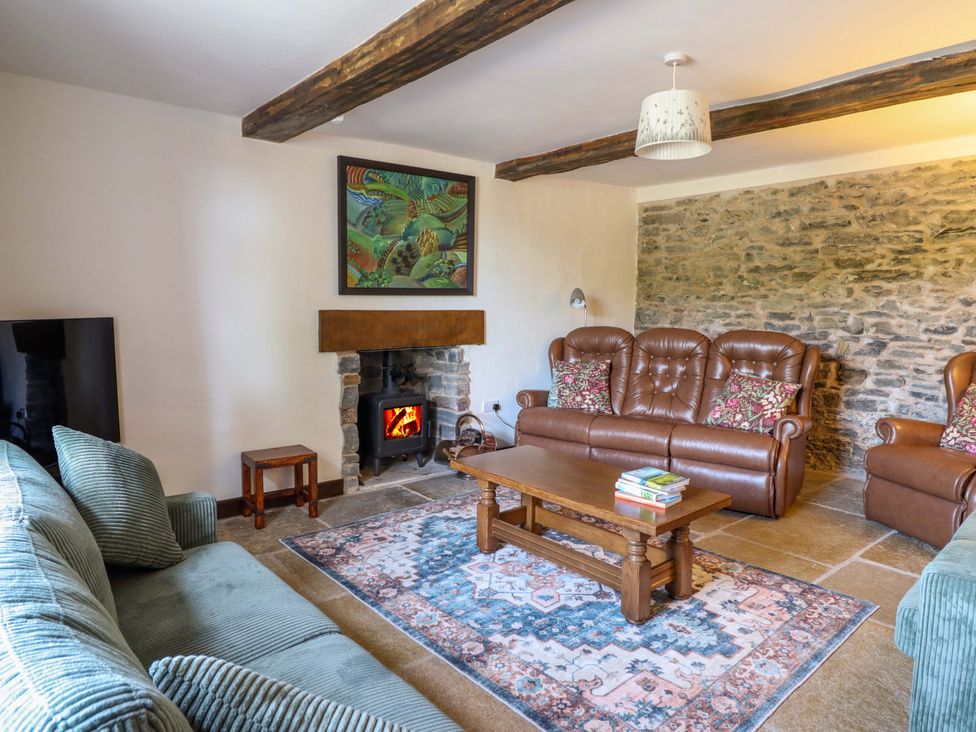 A living room with a sofa and fireplace at Upper Dolarddyn Castle Caereinion