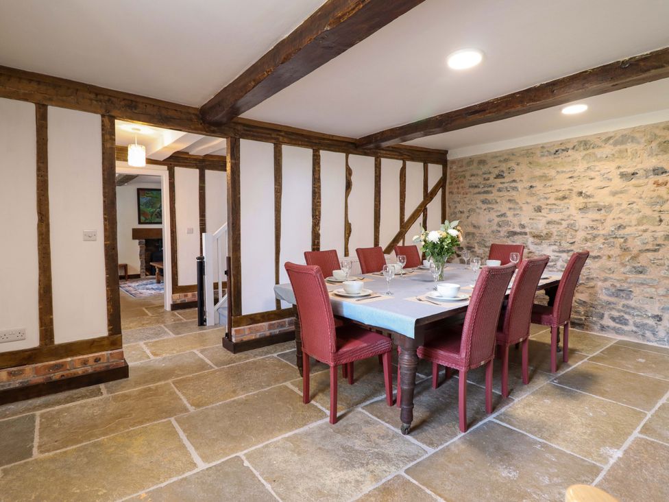 A dining room with a table and chairs at Upper Dolarddyn in Castle Caereinion