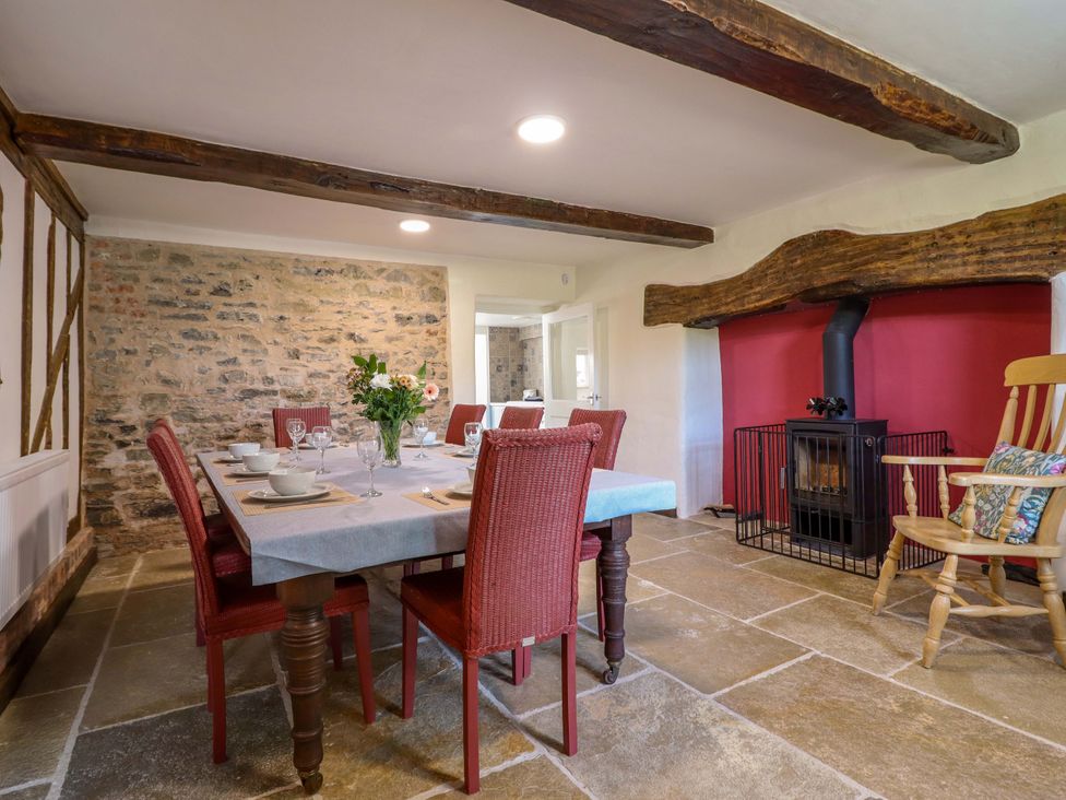 A dining room with a table and chairs at Upper Dolarddyn in Castle Caereinion