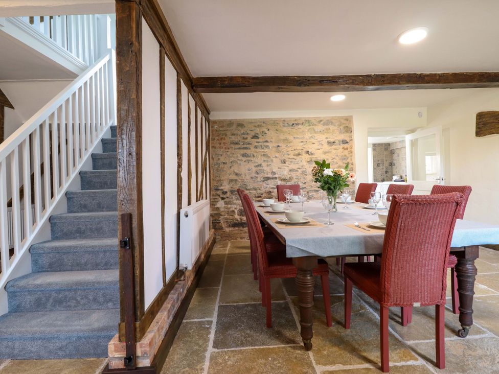 A dining room with a table and chairs at Upper Dolarddyn in Castle Caereinion