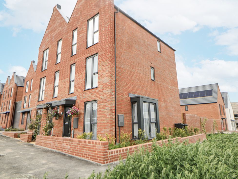 A brick house with windows and plants at Peak Avenue Retreat in Wingerworth near Chesterfield