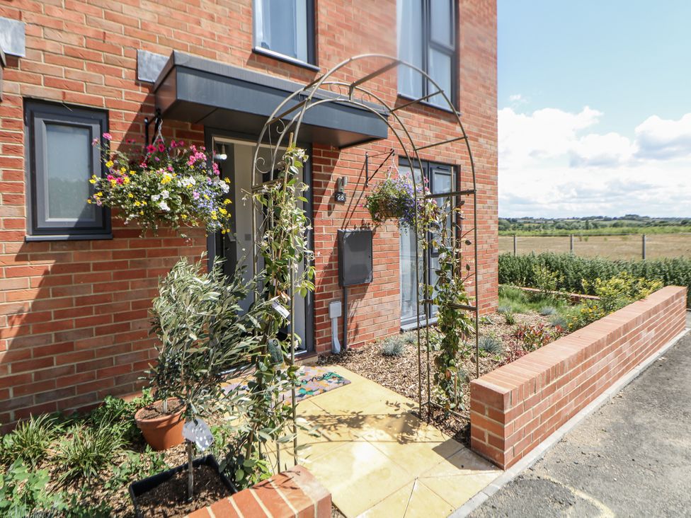 An entrance with an archway and flowers at Peak Avenue Retreat in Wingerworth near Chesterfield