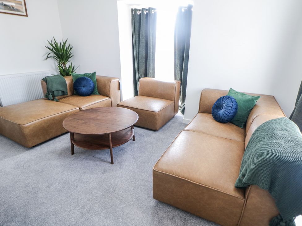 A living room with a sofa, armchair, and coffee table at Peak Avenue Retreat in Wingerworth near Chesterfield