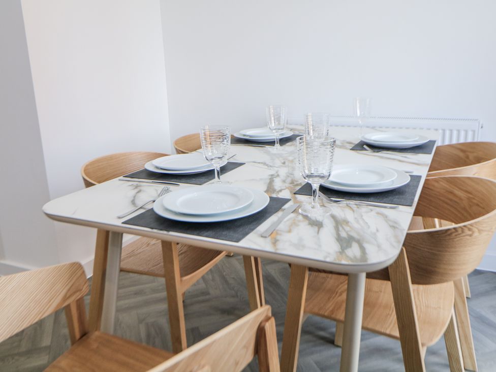 A dining room with a table set for meals at Peak Avenue Retreat Wingerworth near Chesterfield