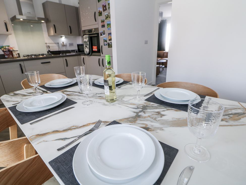 A dining room table set with plates and glasses at Peak Avenue Retreat in Wingerworth near Chesterfield