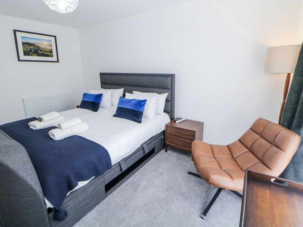 A bedroom with a bed and armchair at Peak Avenue Retreat Wingerworth near Chesterfield