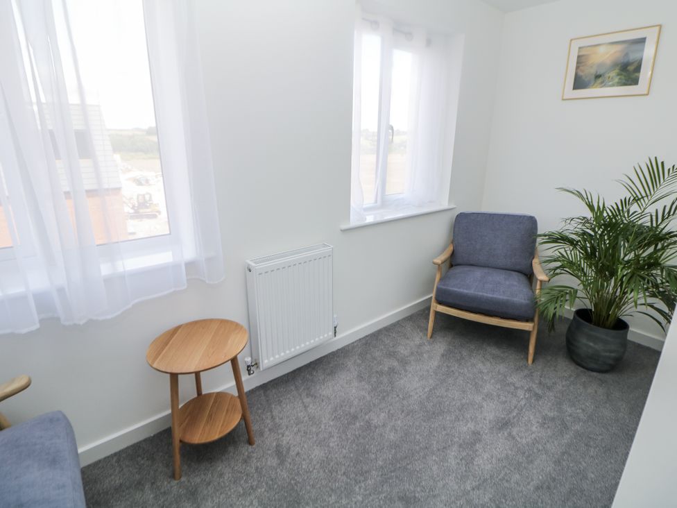 A snug with a chair, table, and plant at Peak Avenue Retreat in Wingerworth near Chesterfield