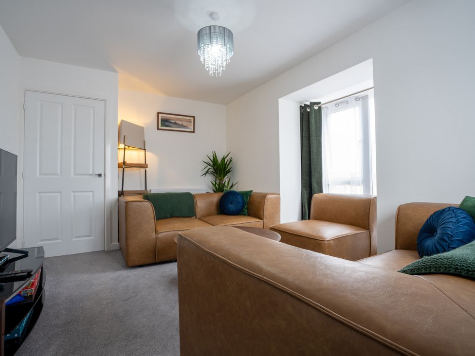 A living room with a sofa and armchair at Peak Avenue Retreat in Wingerworth near Chesterfield