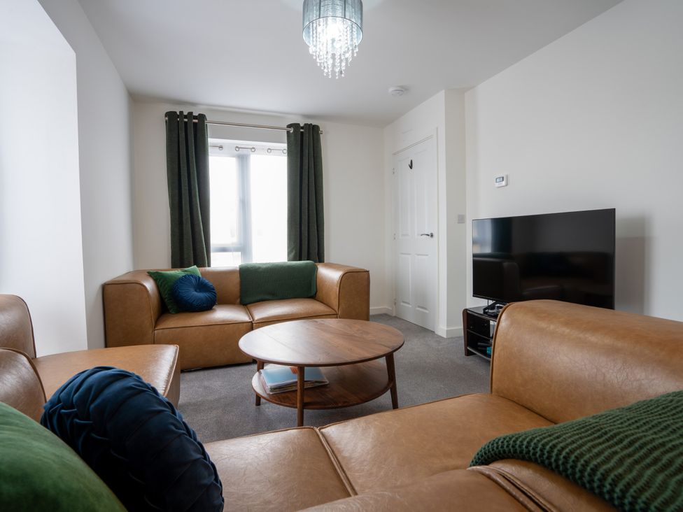 A living room with a coffee table and a television at Peak Avenue Retreat in Wingerworth near Chesterfield