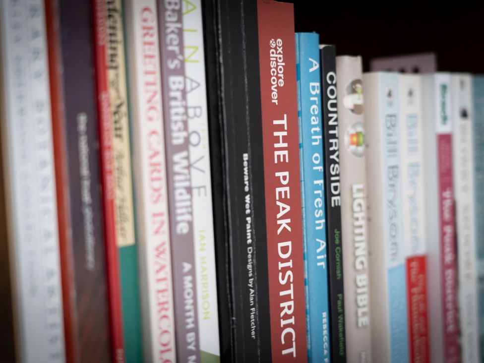A collection of books on a shelf at Peak Avenue Retreat Wingerworth near Chesterfield