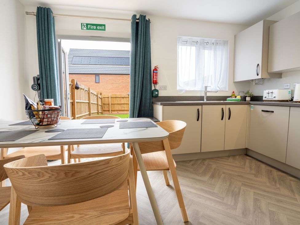 A kitchen with a table and chairs at Peak Avenue Retreat in Wingerworth near Chesterfield