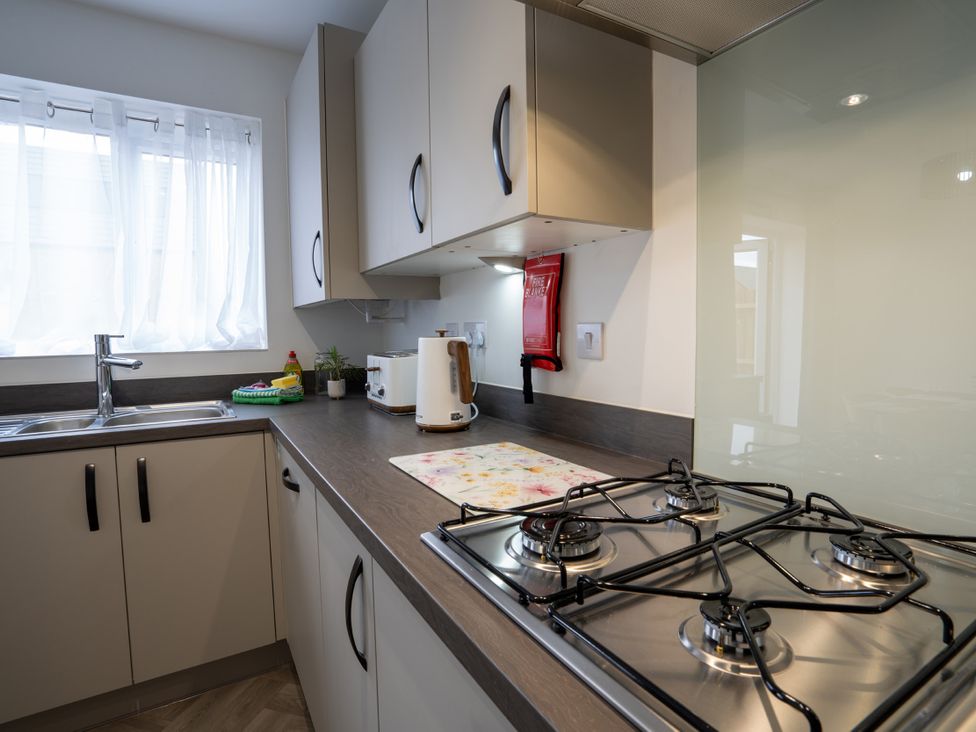 A kitchen with cabinets and a sink at Peak Avenue Retreat in Wingerworth near Chesterfield