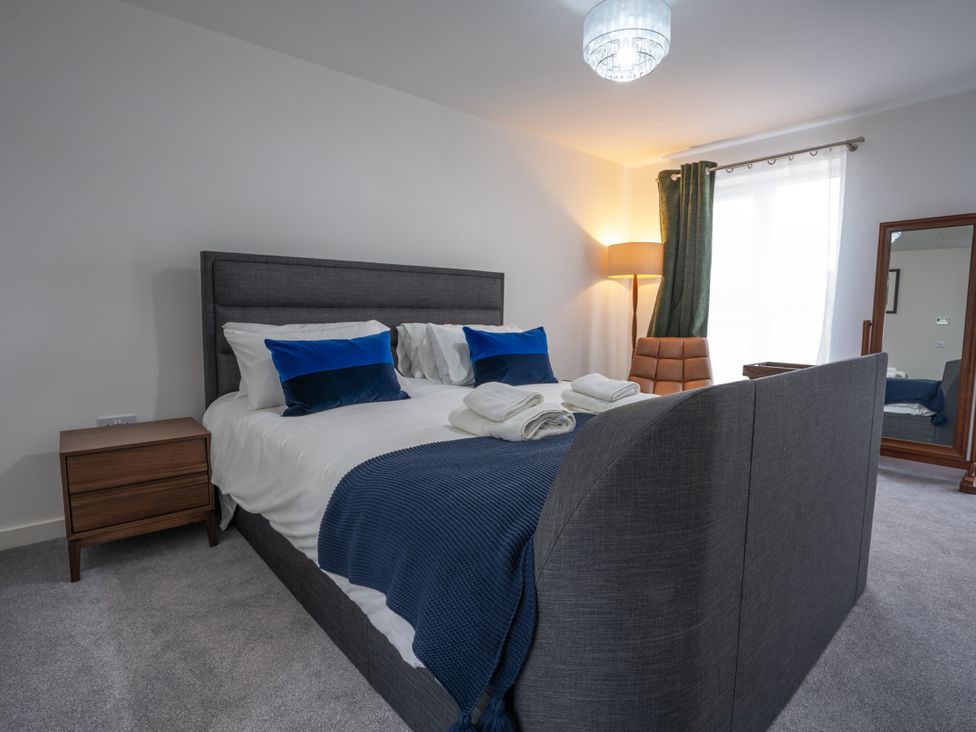 A bedroom with a bed and bedside table at Peak Avenue Retreat in Wingerworth near Chesterfield