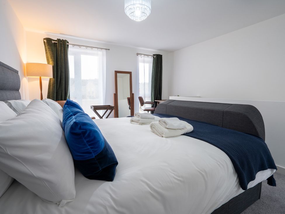 A bedroom with a bed and a chair at Peak Avenue Retreat Wingerworth near Chesterfield